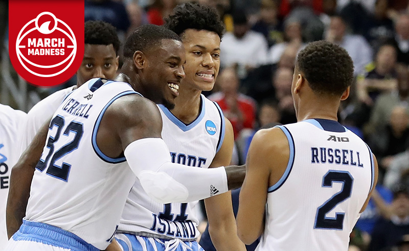 Jared Terrell, Jeff Dowtin and Fatts Russell of the Rhode Island Rams celebrate during the 2018 NCAA Men's Basketball Tournament.