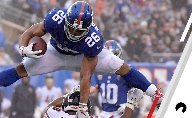 New York Giants running back Saquon Barkley (26) leaps over Chicago Bears strong safety Adrian Amos (38) during the second half of an NFL football game, Sunday, Dec. 2, 2018, in East Rutherford, N.J.