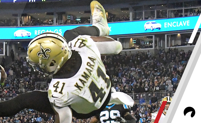 Alvin Kamara #41 of the New Orleans Saints attempts to leap over Eric Reid #25 of the Carolina Panthers during the fourth quarter at Bank of America Stadium on December 17, 2018 in Charlotte, North Carolina. 