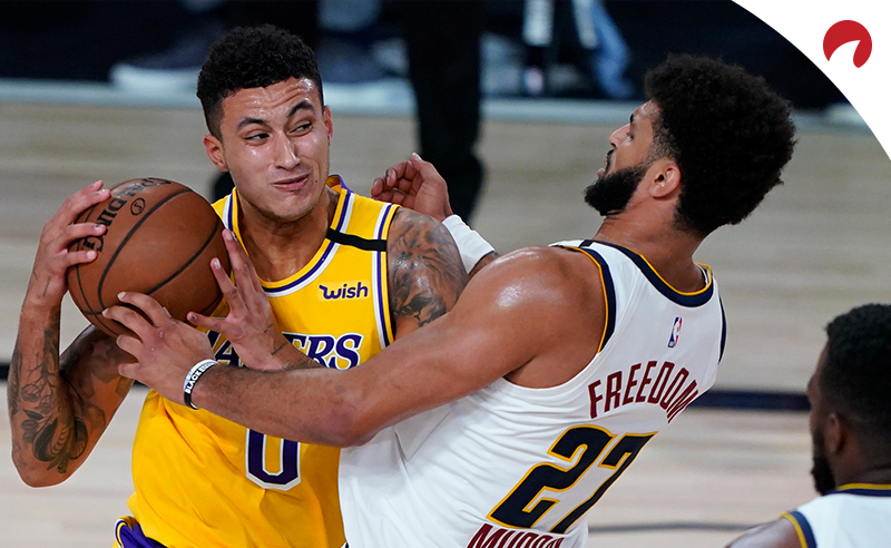 Kyle Kuzma (0) of the Los Angeles Lakers drives to the basket against Jamal Murray (27) of the Denver Nuggets during an NBA game on August 10, 2020, in Lake Buena Vista, Florida.