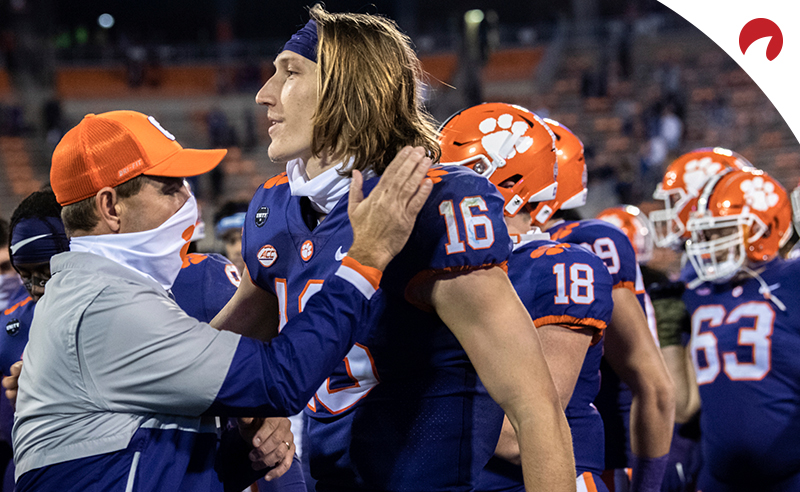 Clemson head coach Dabo Swinney, left, pats Clemson quarterback Trevor Lawrence (16) on the shoulder following their win over Pittsburgh in an NCAA college football game in Clemson, S.C., on Nov. 28, 2020.