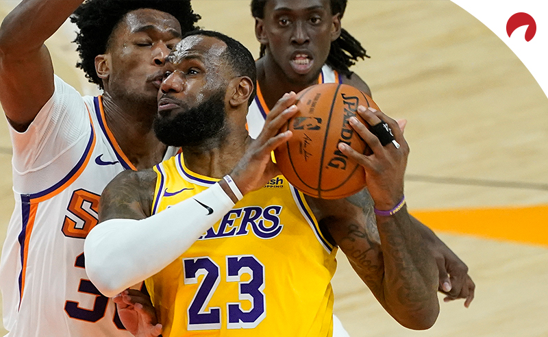 Los Angeles Lakers forward LeBron James (23) drives past Phoenix Suns center Damian Jones (30) during a preseason basketball game on Dec. 18, 2020, in Phoenix, Ariz.