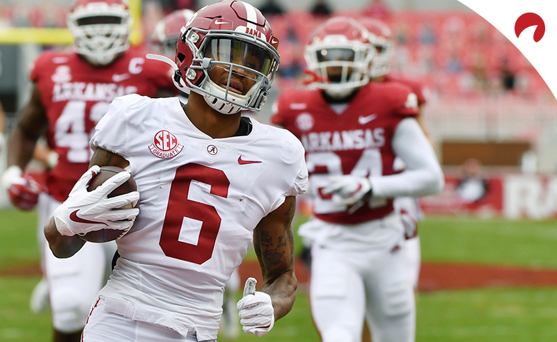 Alabama's DeVonta Smith (6) returns a punt for a touchdown against Arkansas during an NCAA college football game on Dec. 12, 2020, in Fayetteville, Ark.