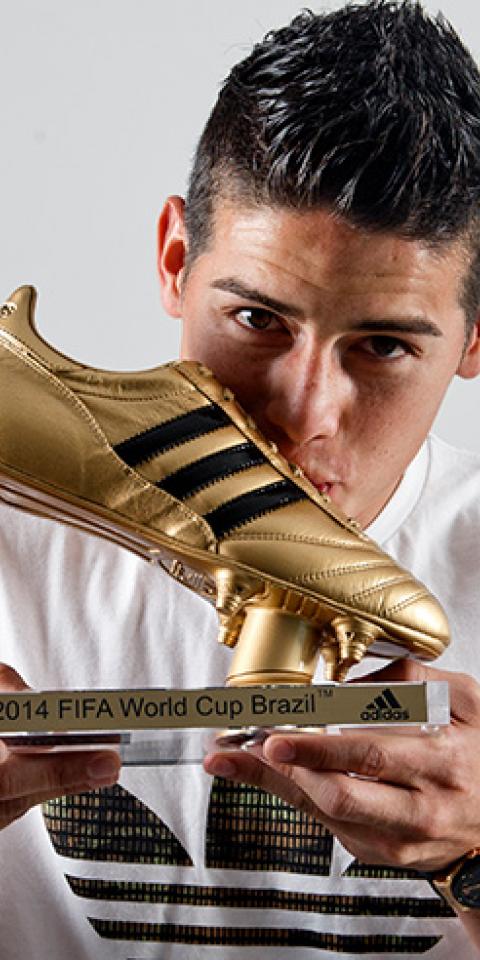 Footballer James Rodriguez receives his Golden Boot Trophy in recognition of scoring the most goals during the 2014 FIFA World Cup 