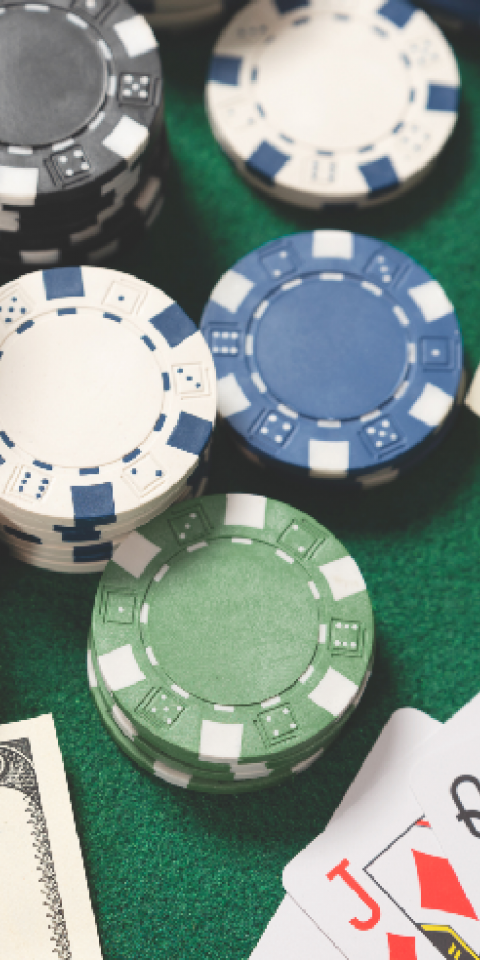 online poker banking money, chips, and cards on table