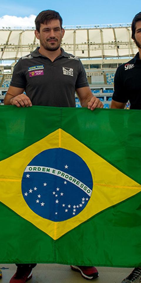 Leo Santos, Demian Maia and Erick Silva pose for a photo with the Brazilian flag