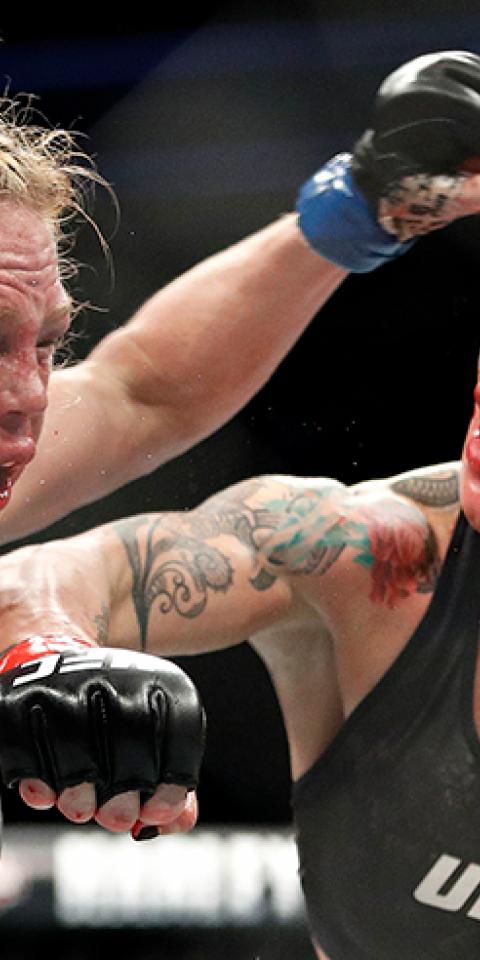 Cris Cyborg hits Holly Holm during a featherweight championship bout at UFC 219.