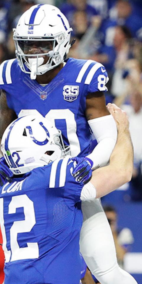 Andrew Luck #12 of the Indianapolis Colts lifts Chester Rogers #80 after the winning touchdown during the game against the New York Giants at Lucas Oil Stadium on December 23, 2018 in Indianapolis, Indiana.