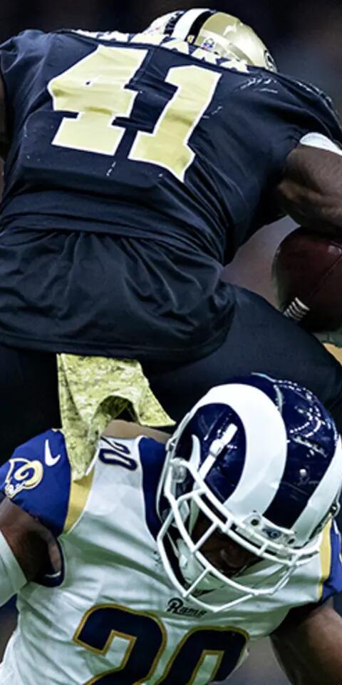 Alvin Kamara #41 of the New Orleans Saints runs the ball and leaps over Lamarcus Joyner #20 of the Los Angeles Rams at Mercedes-Benz Superdome on November 4, 2018 in New Orleans, Louisiana. The Saints defeated the Rams 45-35.