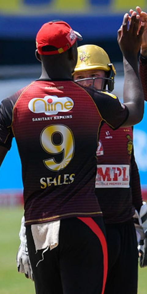 Sunil Narine (R) and Jayden Seales (2L) of Trinbago Knight Riders celebrate the dismissal of Shai Hope of Barbados Tridents during the Hero Caribbean Premier League.