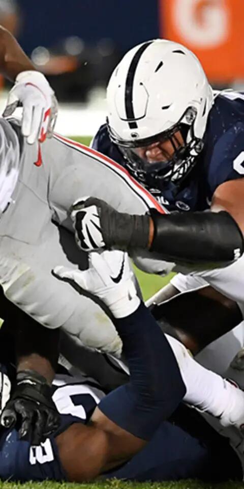 Ohio State running back Master Teague (33) is tackled by Penn State defensive tackle PJ Mustipher (97) and another Penn State player during an NCAA college football game in State College, Pa., on Saturday, Oct. 31, 2020.